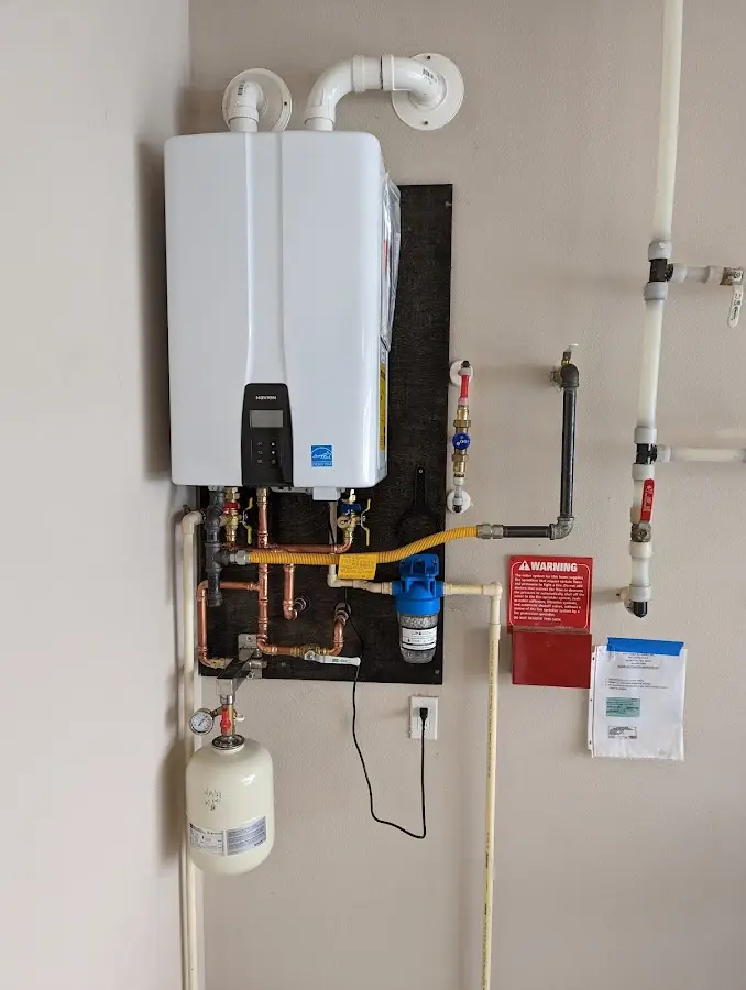 Professional plumber installing copper piping in a Brookdale home